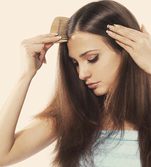Woman brushing her thick hair
