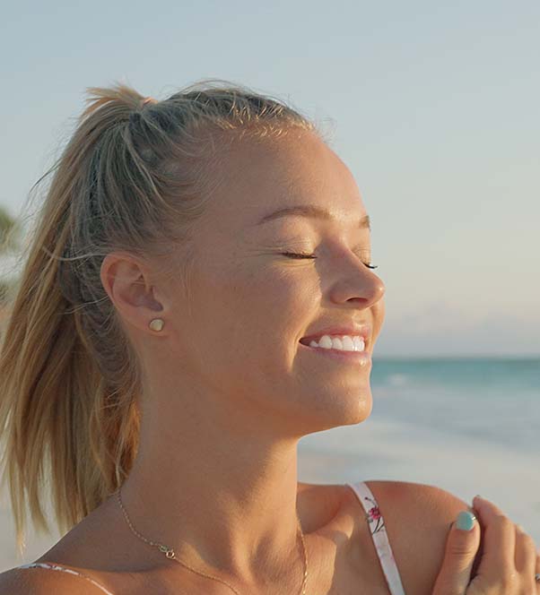 Blonde woman at the beach during sunset