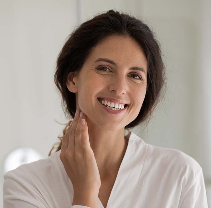 Woman smiling after receiving laser skin rejuvenation